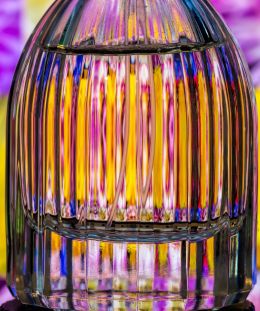 colours behind a perfume bottle.